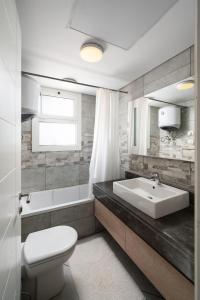 a white bathroom with a sink and a toilet at New Giza Boho Bliss in Abū Rawwāsh