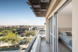 a balcony with a bed and a view of the city at New Giza Boho Bliss in Abū Rawwāsh