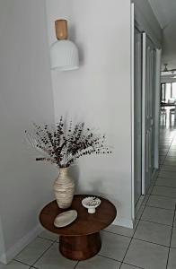 a vase sitting on a table in a room at Palmview Escape in Yorkeys Knob