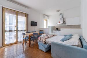 a bedroom with a bed and a table and chairs at Andora See Breeze in Marina dʼAndora