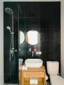 a bathroom with a sink and a shower and a toilet at Luxurious Semeniyak new 2BR villa with a pool in Seminyak +15 photos