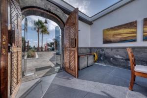 an entrance to a house with a wooden door at Casita Malvika - Luxury and Sea view - 1min to the Beach By Lanzarote Vacation Homes in Costa Teguise