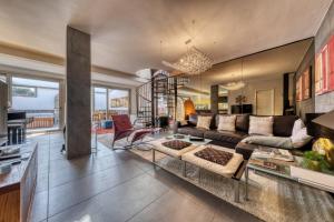 a living room with a couch and a table at Casita Malvika - Luxury and Sea view - 1min to the Beach By Lanzarote Vacation Homes in Costa Teguise