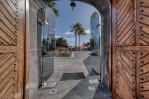 an entrance to a building with a glass door at Casita Malvika - Luxury and Sea view - 1min to the Beach By Lanzarote Vacation Homes in Costa Teguise +57 photos