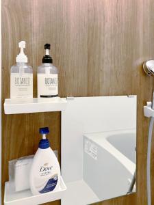 a bathroom with two bottles of soap and a sink at カレラ豊平2nd in Sapporo