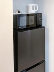 a microwave sitting on top of a refrigerator at カレラ豊平2nd in Sapporo +120 photos