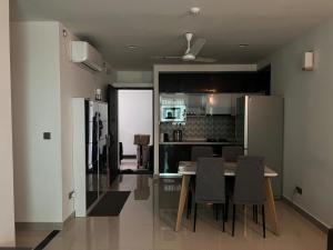 a kitchen and dining room with a table and chairs at Hiyaa A in Hulhumale