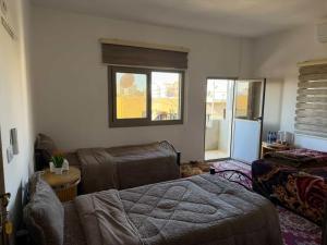 a living room with a bed and a couch at Eman house in Wadi Musa