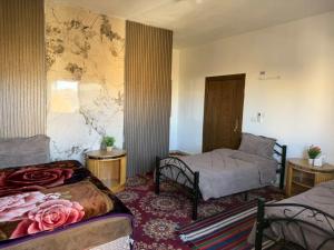 a room with two beds in a room with a map on the wall at Eman house in Wadi Musa