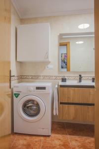 a washing machine in a bathroom with a sink at Castillo Buenavista in Ponferrada +18 photos
