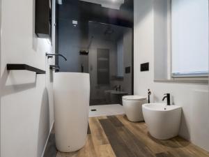 ein Badezimmer mit zwei weißen WCs und einem Waschbecken in der Unterkunft Cesalpino 5 in Arezzo