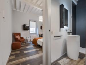 Ein weißes Zimmer mit einem Bett und einem Bad. in der Unterkunft Cesalpino 5 in Arezzo + 4 Fotos