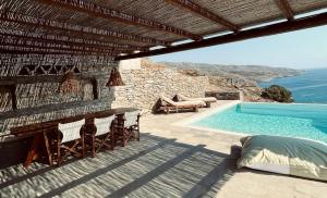 a villa with a swimming pool and a resort at Conte Kea in Koundouros