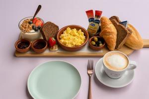 a tray with breakfast foods and a cup of coffee at  