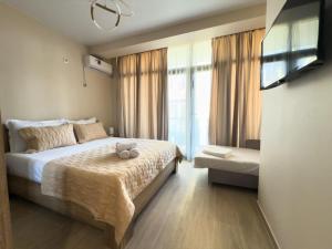 a bedroom with a bed with a teddy bear on it at Villas David in Ureki