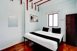 Ένα ή περισσότερα κρεβάτια σε δωμάτιο στο HOTEL O MID STAR +26 φωτογραφίες