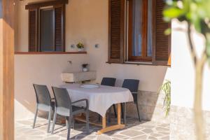 a table and chairs sitting on a patio at Appartamenti La Chiocciola by ElbaSummer in Lacona