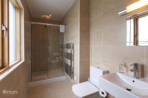 a bathroom with a shower and a toilet and a sink at Waters Edge 04, Waterside Lodge P in South Cerney +22 photos