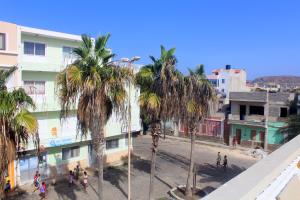 a city street with palm trees and buildings at Residence A Paz in Boa Ventura