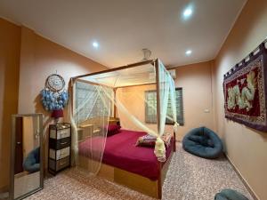 a bedroom with a canopy bed with a mirror at Beachfront bungalow south of Phuket in Phuket Town