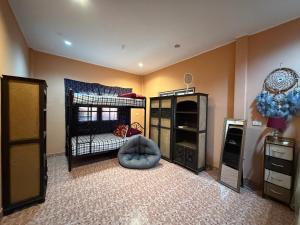a childs bedroom with a bed and a crib at Beachfront bungalow south of Phuket in Phuket Town