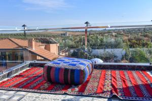 a large mattress sitting on top of a rug on a roof at Tynass Ferme - Fes in Fez