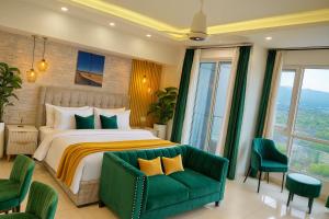a bedroom with a bed and a green couch at Elysium Tower Luxury Studio & One Bedroom Apartments Opposite Centaurus Mall Islamabad in Islamabad +151 photos