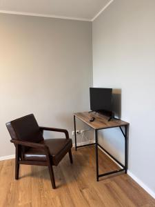 a chair and a desk with a computer on it at ZV38-Mammut-3 in Salzgitter