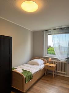 a small bedroom with a bed and a window at ZV38-Mammut-3 in Salzgitter