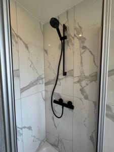 a shower with a black shower head in a bathroom at ZV38-Mammut-3 in Salzgitter +8 photos