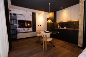 a kitchen and dining room with a table and chairs at Kron in Novi Sad