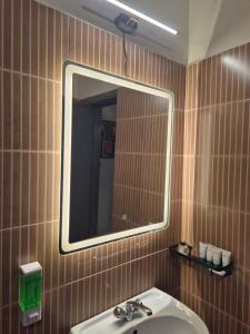 a bathroom with a sink and a mirror at The Palm Villa in Jaipur +14 photos