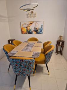 a dining room with a table and chairs at The Palm Villa in Jaipur