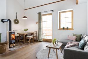 a living room with a couch and a fireplace at Sloho Bergurlaub - Adults Only in Hohentauern