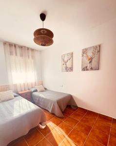 a bedroom with two beds and a ceiling at La Osera in Arroyo Frio +16 photos