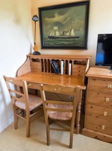 a wooden desk with a chair and a desk with a boat on it at Residence Hotel Les Ducs De Chevreuse avec Hébergement, Repas & PDJ, Séminaire, Bureau & Parking in Chevreuse +44 photos