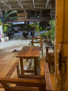 a group of tables and benches in a room at The Panda Backpacker Hostel in Kampot