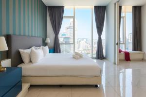 a bedroom with a large bed and a large window at The Platinum Kuala Lumpur by MAHA in Kuala Lumpur +41 photos