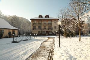 a large building in the snow in front at Bogolvar Retreat Resort in Antonovka