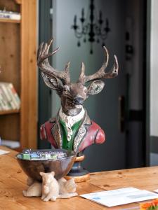 a statue of a deer with antlers in a bowl on a table at Residence Hotel Les Ducs De Chevreuse avec Hébergement, Repas & PDJ, Séminaire, Bureau & Parking in Chevreuse