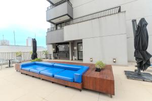 niebieska kanapa przed budynkiem w obiekcie Seu Refúgio Urbano na Bela Vista w São Paulo