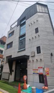a building with an orange cone in front of it at Bombay Residence SNU Nakseongdae Station in Seoul