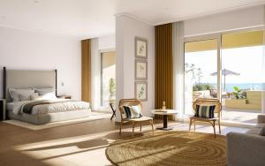 ein Schlafzimmer mit einem Bett und zwei Stühlen in der Unterkunft Iberostar Selection Montenegro in Topolica