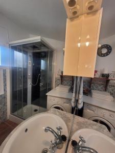 a bathroom with two sinks and a shower at Casa de la Luz in Cuevas del Campo +22 photos