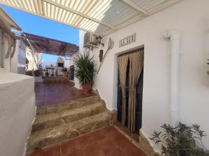 a entrance to a house with stairs and a door at Casa de la Luz in Cuevas del Campo