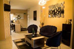 a living room with two chairs and a table at Hotel In the heart of Old Bazaar with private parking in Skopje