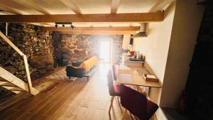 a view of a living room with a stone wall at Cozy House with Douro View in Lamego