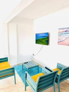 a room with two chairs and a table at Devika villa in Triolet