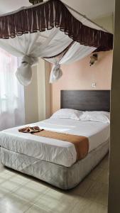 Ένα ή περισσότερα κρεβάτια σε δωμάτιο στο Loiusiana City Hotel