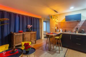 a kitchen with yellow chairs and a table and a counter at Twilight Star Spa - Sauna & Private Cinema - Free Parking in Amiens